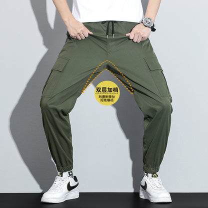 Person wearing green baggy pants with a focus on the design and features, against a plain background.