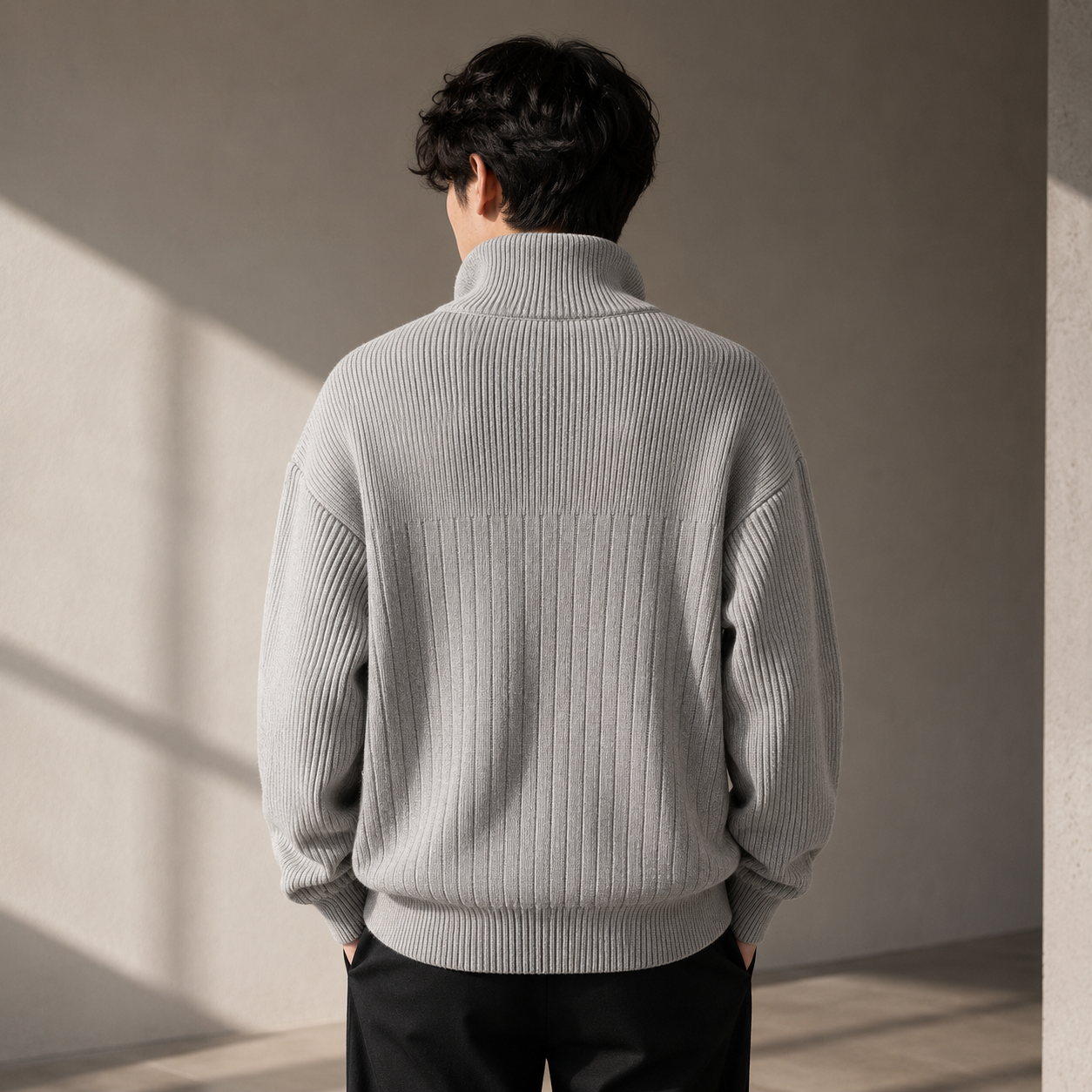 Male model wearing gray half-zip ribbed sweater back view