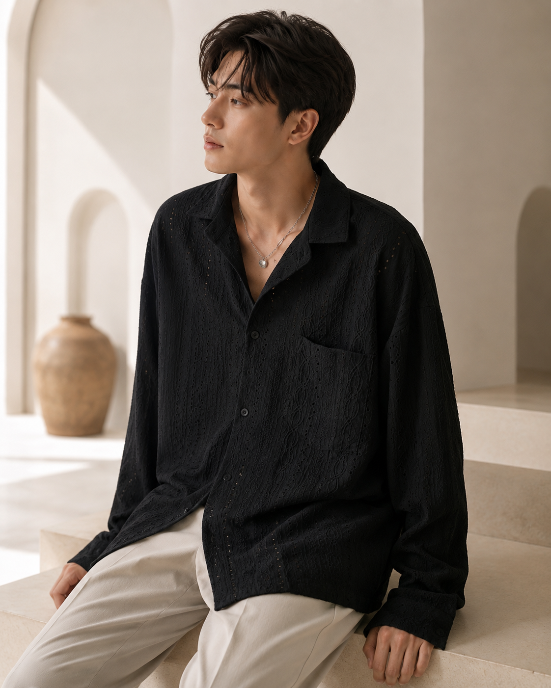 Male model wearing black hollow-knit luxury long-sleeve shirt