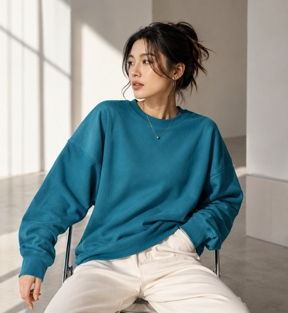 Asian female model wearing teal heavyweight crewneck sweatshirt