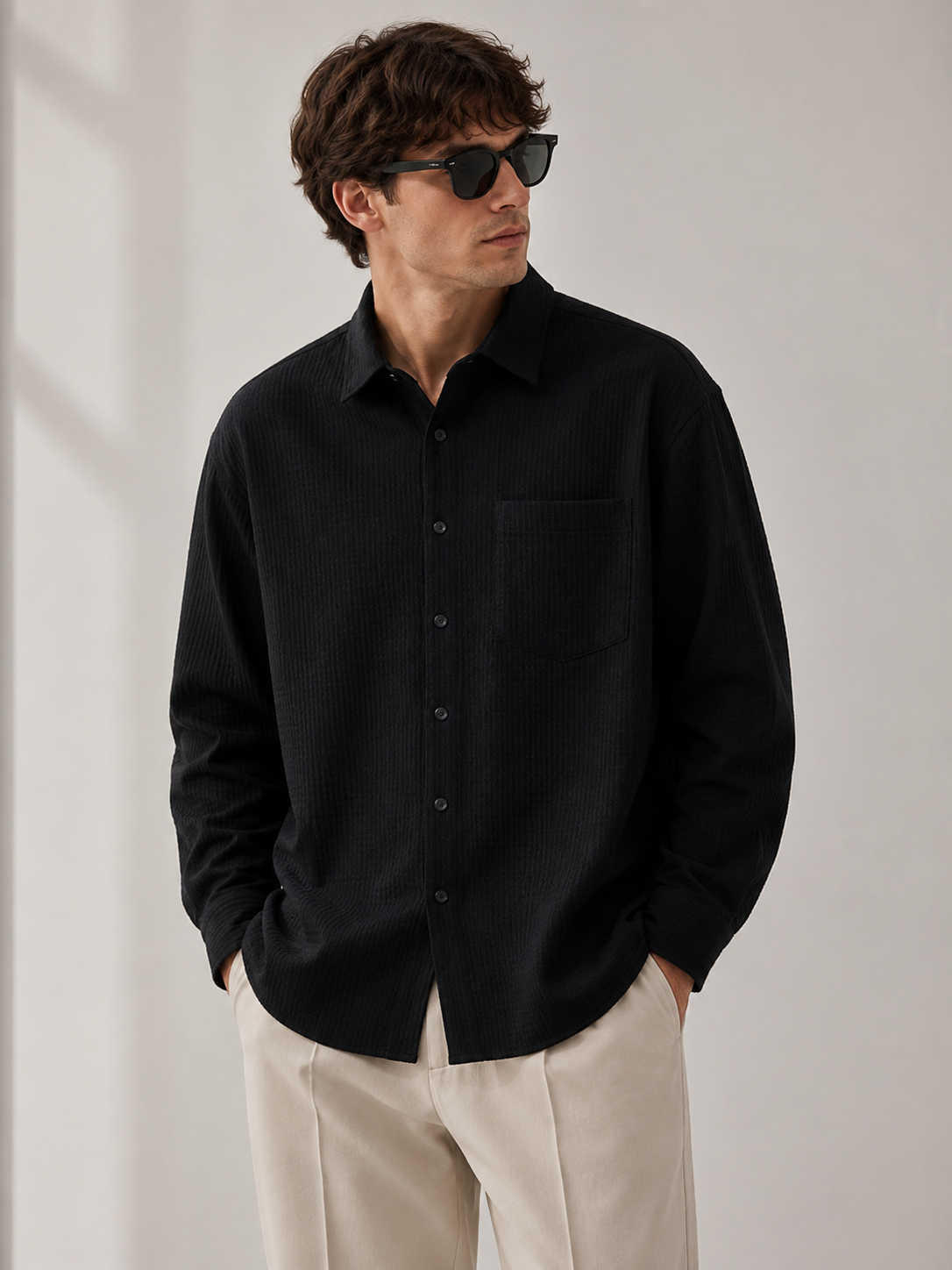 Male model wearing black textured long-sleeve shirt